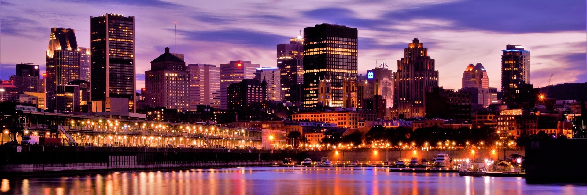Montreal, Canada: illuminated city skyline along the waterfront at dusk