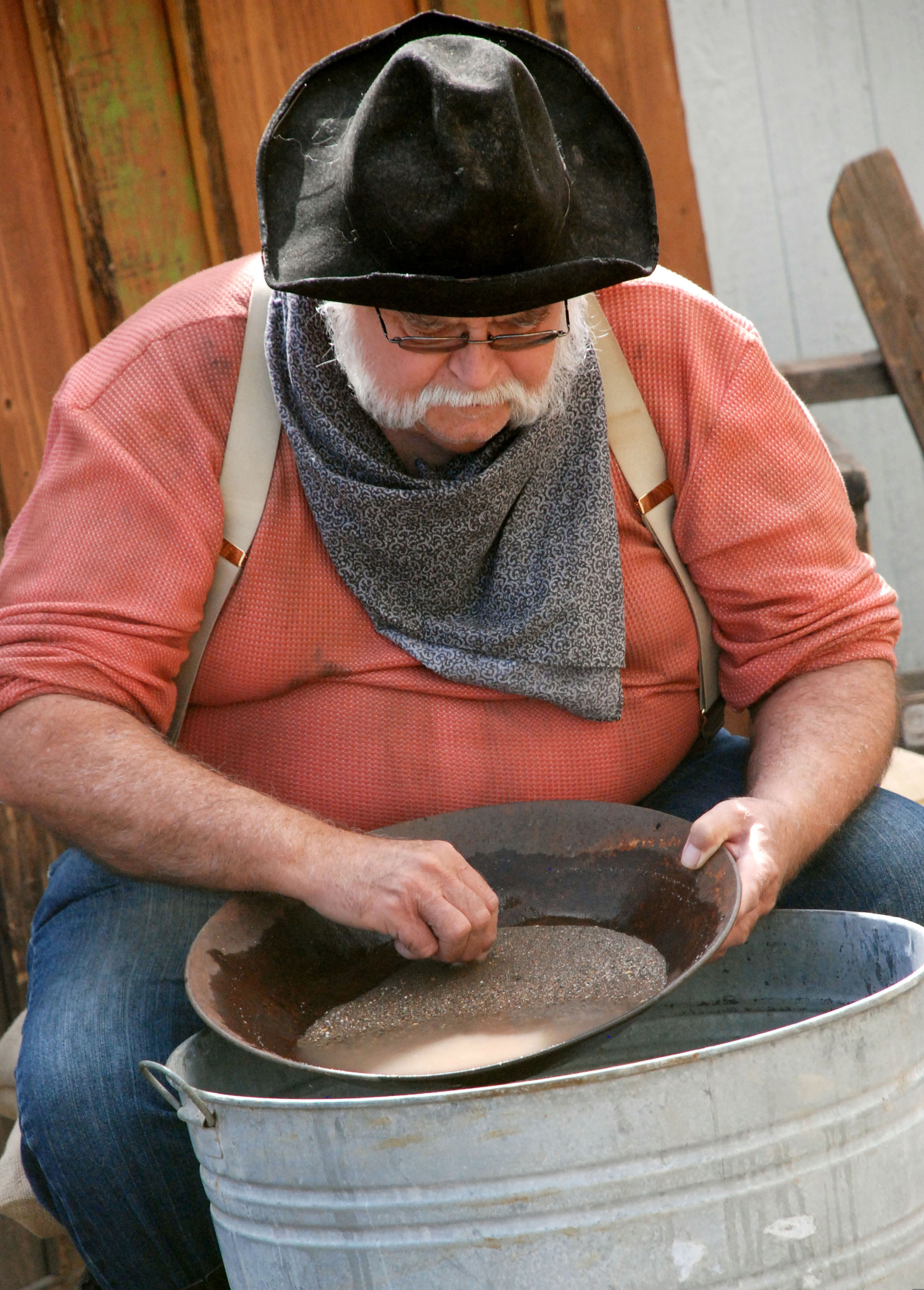 Fairbanks, Alaska: a gold panner in period costume panning for gold over a tub